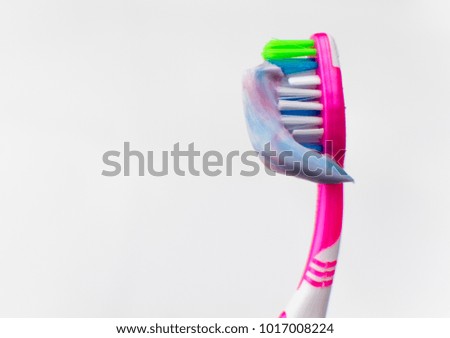 Toothbrush with squeezed toothpaste  on a white background.