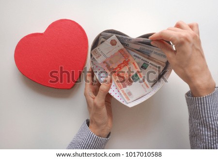 Gift box in form of heart with money inside. Russian money in the box.