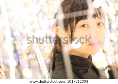 Young pretty girl wearing black cotton sweatshirt on bokeh background at night