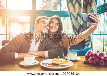 The happy couple making a selfie in a restaurant