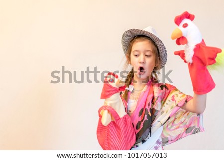 girl 8 years playing in the puppet theater. copy space