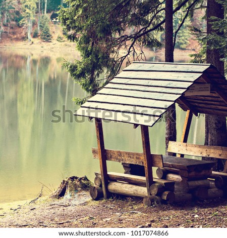 A place to relax, a gazebo near the lake in the mountains. Place for a picnic.