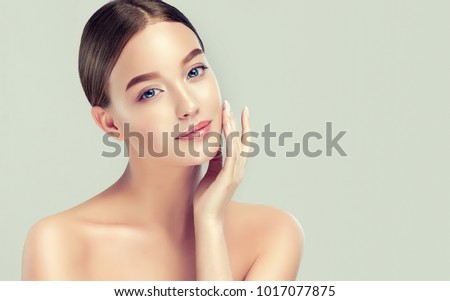 Beautiful young woman with clean fresh skin. Girl  beauty face care. Facial  treatment. Royalty-Free Stock Photo #1017077875