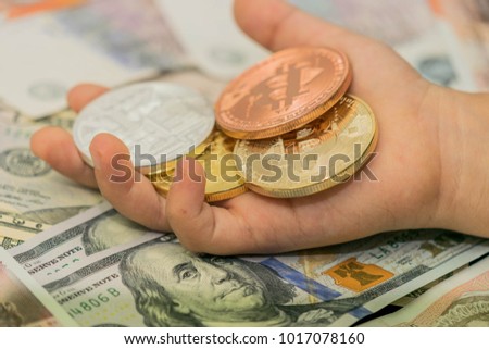 Hand holding Bitcoin virtual money.