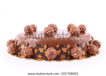 chocolate cake with nuts balls isolated against a white background.