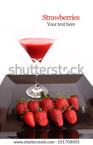 Strawberry juice in a cocktail glass with a fresh strawberries on black Dish Isolated on white