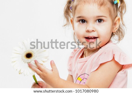 Portrait of a beautiful little cheerful girl on a white background