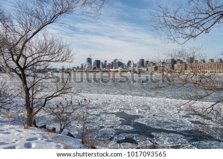 Montreal Skyline in winter, with chunks of ice floating on the Saint-lawrence (2018)