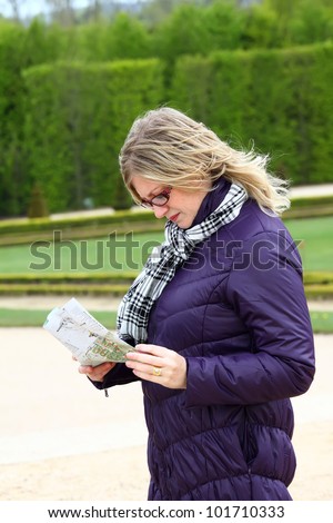 woman with map on cold Paris