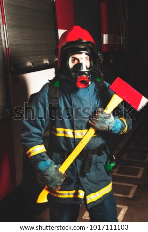 Firefighter rescuer in the aspirator in the background of a fire truck