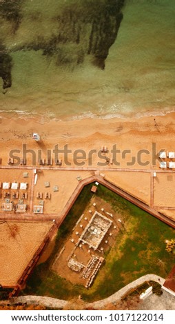 Aerial drone bird's eye photo of famous celebrity sandy beach of Astir or Asteras in south Athens riviera with turquoise clear waters at sunset, Vouliagmeni, Greece