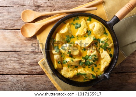 Brazilian food: coconut chicken in a spicy cream sauce close-up on a table. Horizontal top view from above
 Royalty-Free Stock Photo #1017155917