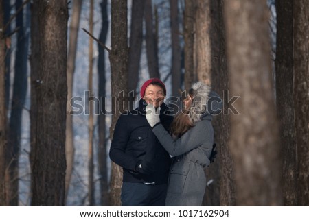 Young beautiful couple playing with snow in wintertime