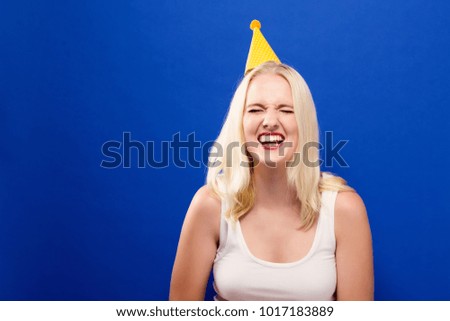 Young woman with party theme on a solid background