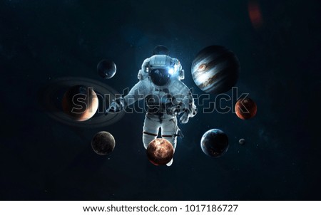 Astronaut and the Solar system. Symbol of space exploration. Elements of this image furnished by NASA