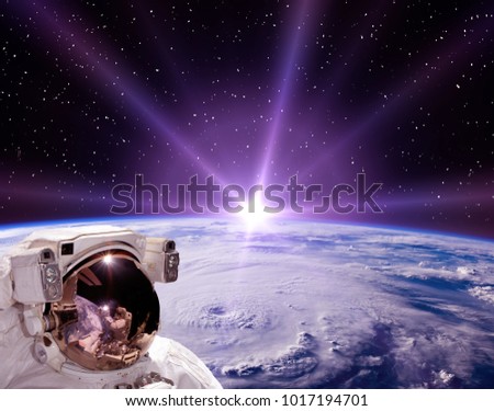 Space and sunrise. Astronaut in cosmos. The elements of this image furnished by NASA.
