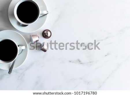 This stock photo of two cups of coffee and pink coffee pods on a marble background provides the perfect backdrop for your graphic overlay. Great for coffee shops, bloggers, store owners, and more!