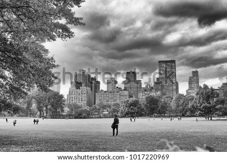 NEW YORK CITY - OCTOBER 25, 2015: Central Park in Autumn with tourists. The city attracts 50 million people every year.