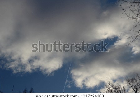 Clouds and plane trails