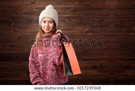 Winter sale concept. Young girl with shopping bag.