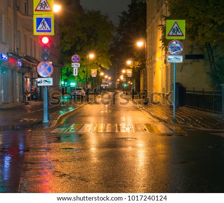 quiet city street at rainy night. background