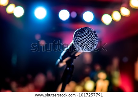 Public performance on stage Microphone on stage against a background of auditorium. Shallow depth of field. Public performance on stage. Royalty-Free Stock Photo #1017257791