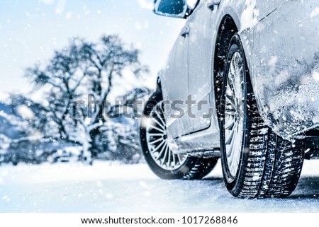 Tire in winter on snow road. Tires on snow. Car detail.