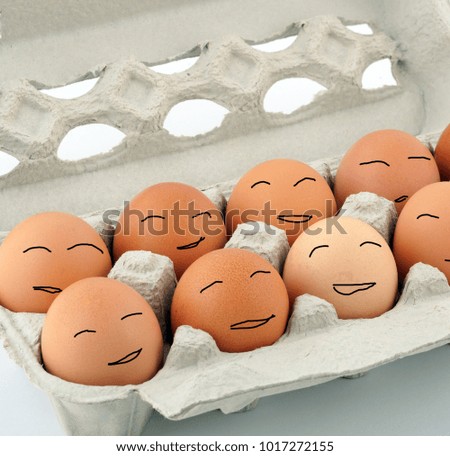 Happy easter eggs with smiling faces in a carton box