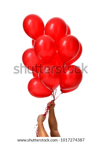 Mans hands hold bunch of big red balloons object for birthday party isolated on a white background
