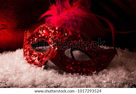Image of elegant red and gold venetian, mardi gras mask over red background