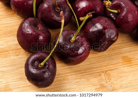 Sweet red cherries on a wooden background.