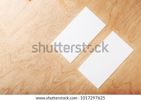 Blank business cards on wooden surface. 