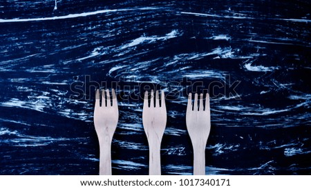 Silver fork lying on a wooden table. 