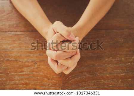 woman praying in morning. Hands folded in prayer
