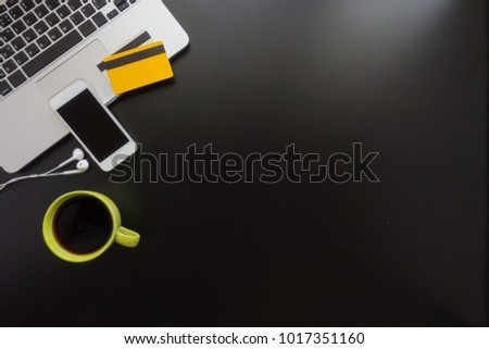 Top view of using credit card and digital tablet computer for buying on line. Online shopping concept.Beautiful hand holding credit card.Man using tablet computer on desk table.Flat lay images.