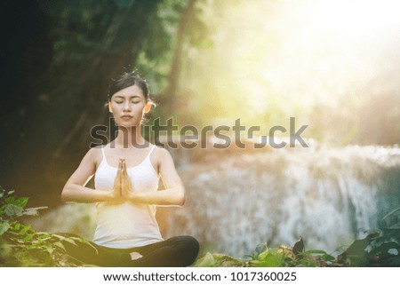 Woman Yoga - relax in waterfall nature.