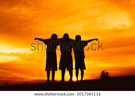 silhouette boys open arm at sunset or sunrise background