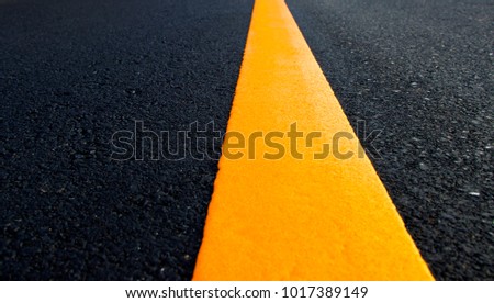 Yellow solid line. Road markings on asphalt on the street.