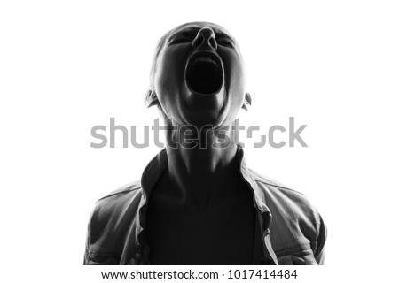 Screaming woman silhouette,back lit light Royalty-Free Stock Photo #1017414484