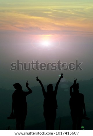 Silhouette of happy photographer team look at beautiful sun rise ,copy space.