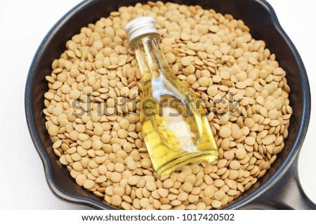 lentils oil with lentils on white background