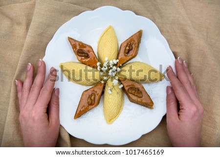 A plate with national pakhlava and shekarbura as Novruz symbol
