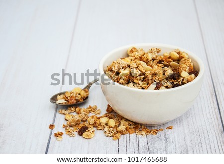 Bowl with granola  on a old wooden table Royalty-Free Stock Photo #1017465688