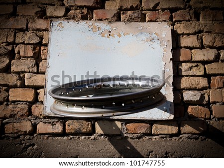 Self-made ring for basketball on a brick wall