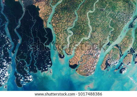 View from space on the Sundarbans, a vast forest in the coastal region of the Bay of Bengal - Modified elements of this image furnished by ESA  Royalty-Free Stock Photo #1017488386