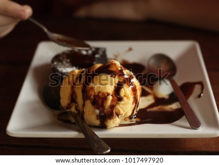 lava chokolate cake with ice cream ball spoon close up photo