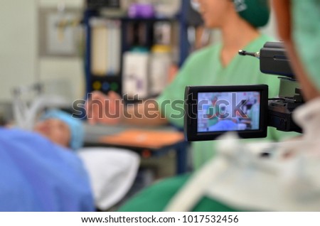 Video shooting in the operating room the necessary equipment is a tripod, Work carefully the images are blurred in part so that the face of the patient and the physician are not visible.