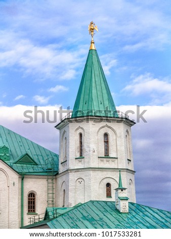 Part of the architectural complex Ratnaya Chamber with a turret, a facade, a spire, a three-headed eagle on a spire against a blue sky in Tsarskoye Selo in Alexander Park St. Petersburg, Russia
