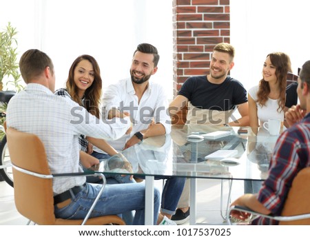 handshake of business partners sitting at the table