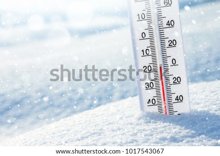 Wintertime. Winter background with  thermometer in the snow on frosty day. Royalty-Free Stock Photo #1017543067
